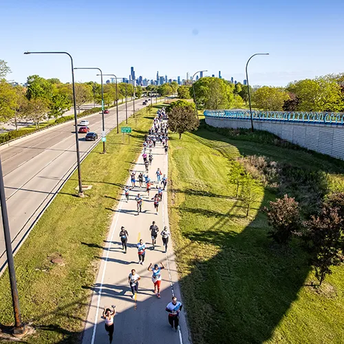 Runners on course with Chicago skyline Runners on course with Chicago skyline